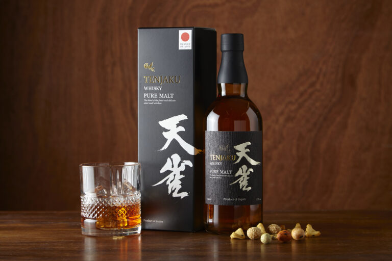 Tenjaku Pure Malt whisky, gift box and filled tumbler on a wooden table.